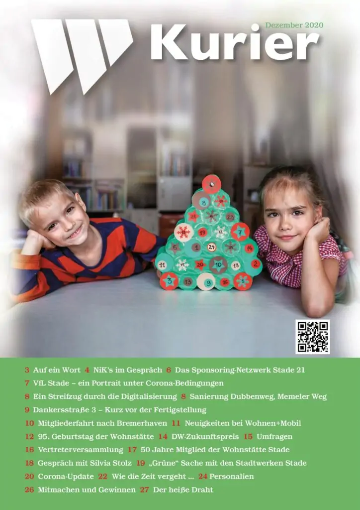 Zwei kleine Kinder, ein Junge und ein M&auml;dchen, sitzen l&auml;chelnd an einem Tisch. Zwischen ihnen steht ein kleiner Weihnachtsbaum, der aus gestapelten gr&uuml;nen Zylindern mit roten Spitzen besteht. Die Szene ist festlich und fr&ouml;hlich, wie auf dem Titelbild einer Zeitschrift.