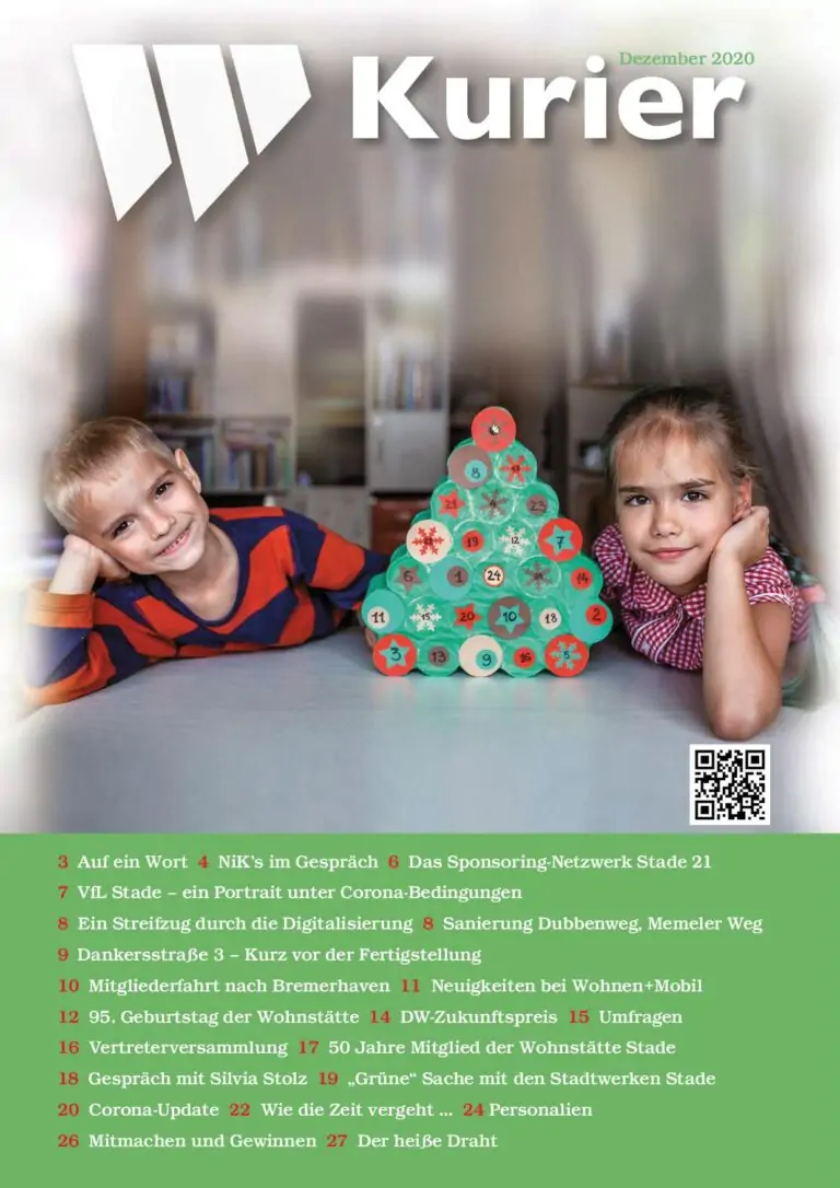 Zwei kleine Kinder, ein Junge und ein Mädchen, sitzen lächelnd an einem Tisch. Zwischen ihnen steht ein kleiner Weihnachtsbaum, der aus gestapelten grünen Zylindern mit roten Spitzen besteht. Die Szene ist festlich und fröhlich, wie auf dem Titelbild einer Zeitschrift.